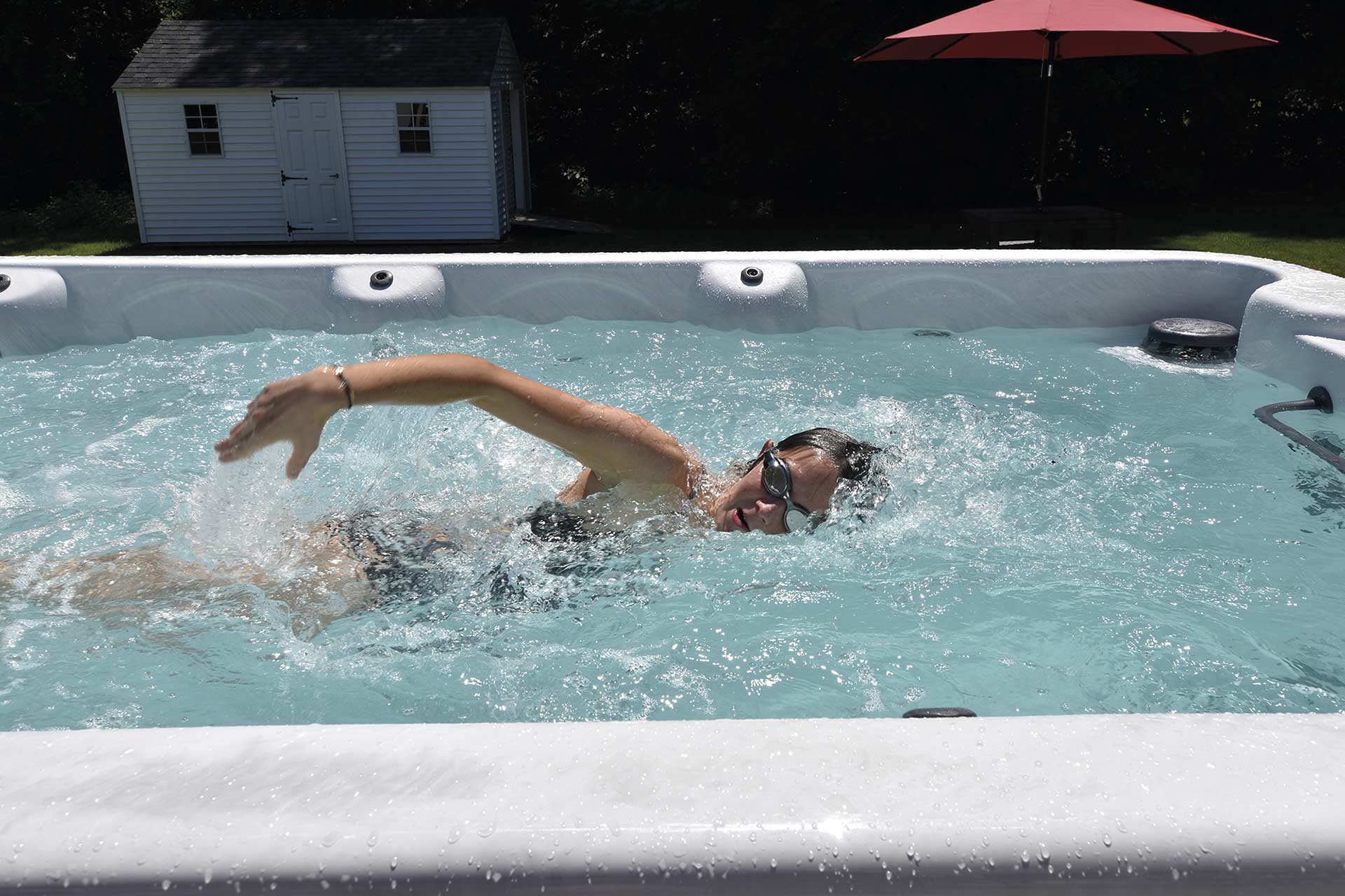 Girl swimming in a swim spa